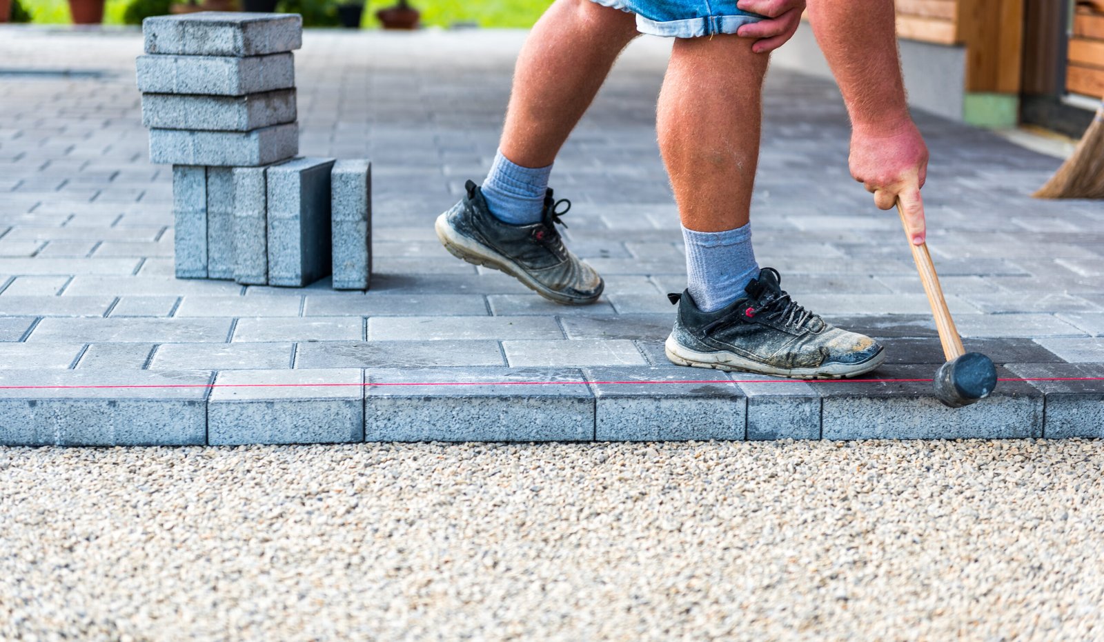 laying gray concrete paving slabs in house courtyard driveway pa